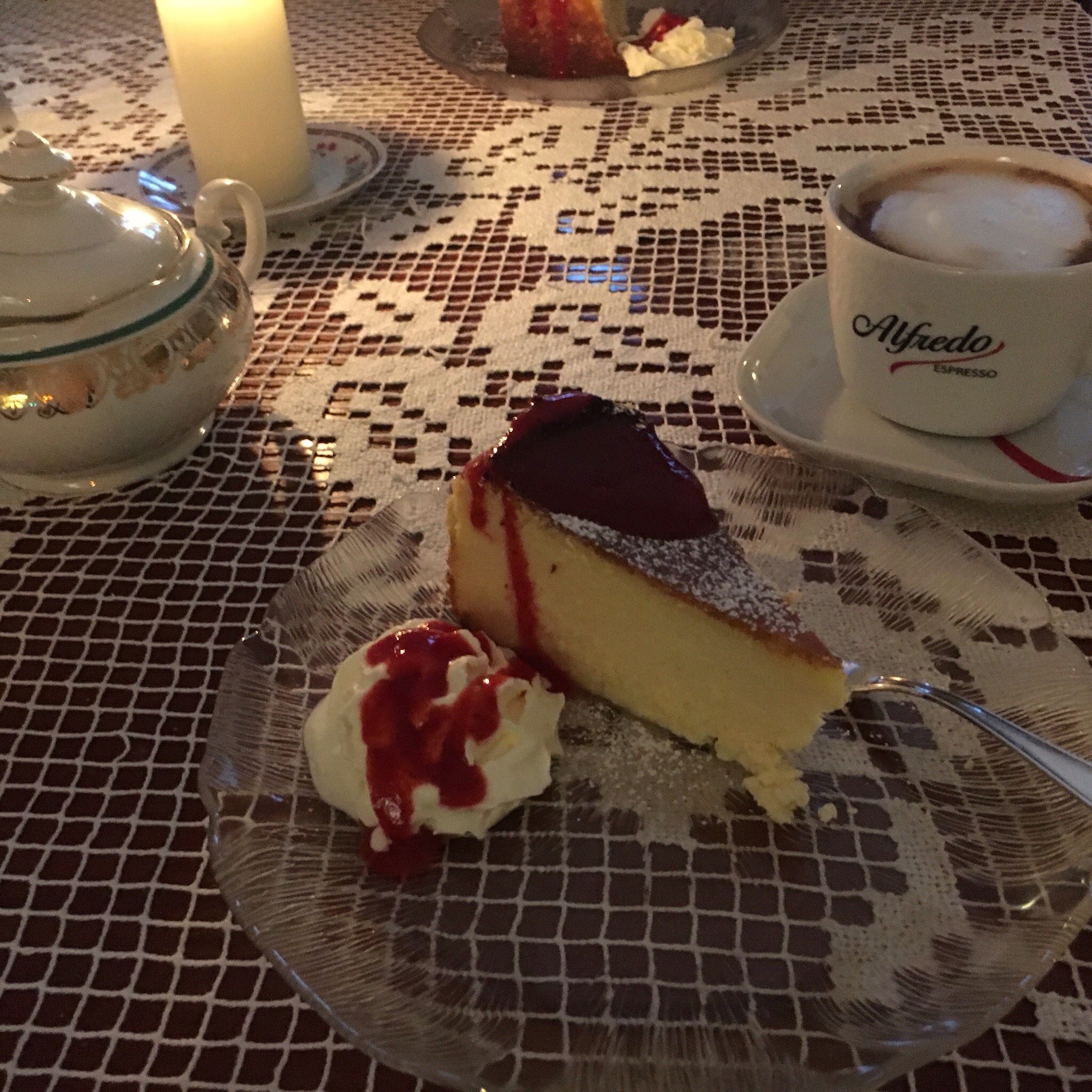 Cheesecake and coffee by candlelight