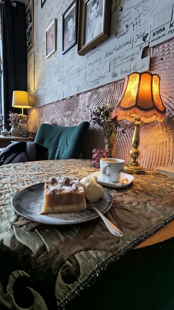 Apple cake with ice cream and coffee by the signature wall